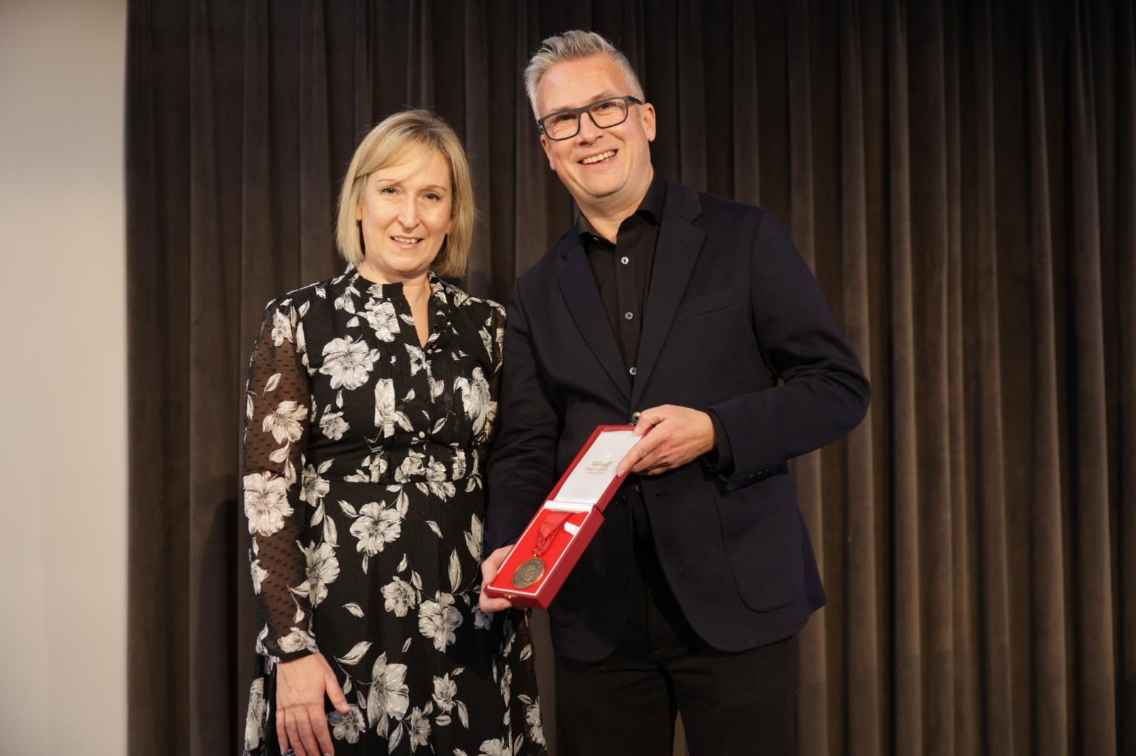 CIPR President Rachael Clamp presenting the Sir Stephen Tallents’ Medal to Iain Anderson at the Institute’s 2024 Annual Conference.